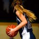 woman in blue and white basketball jersey holding brown basketball