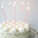 photo of white cake with candles on top